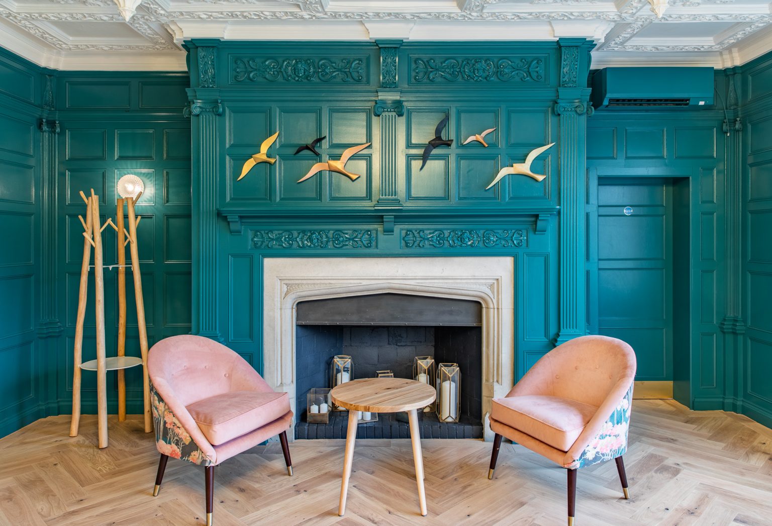 The spa lounge area with two chairs in front of the fire at The Springs hotel and spa
